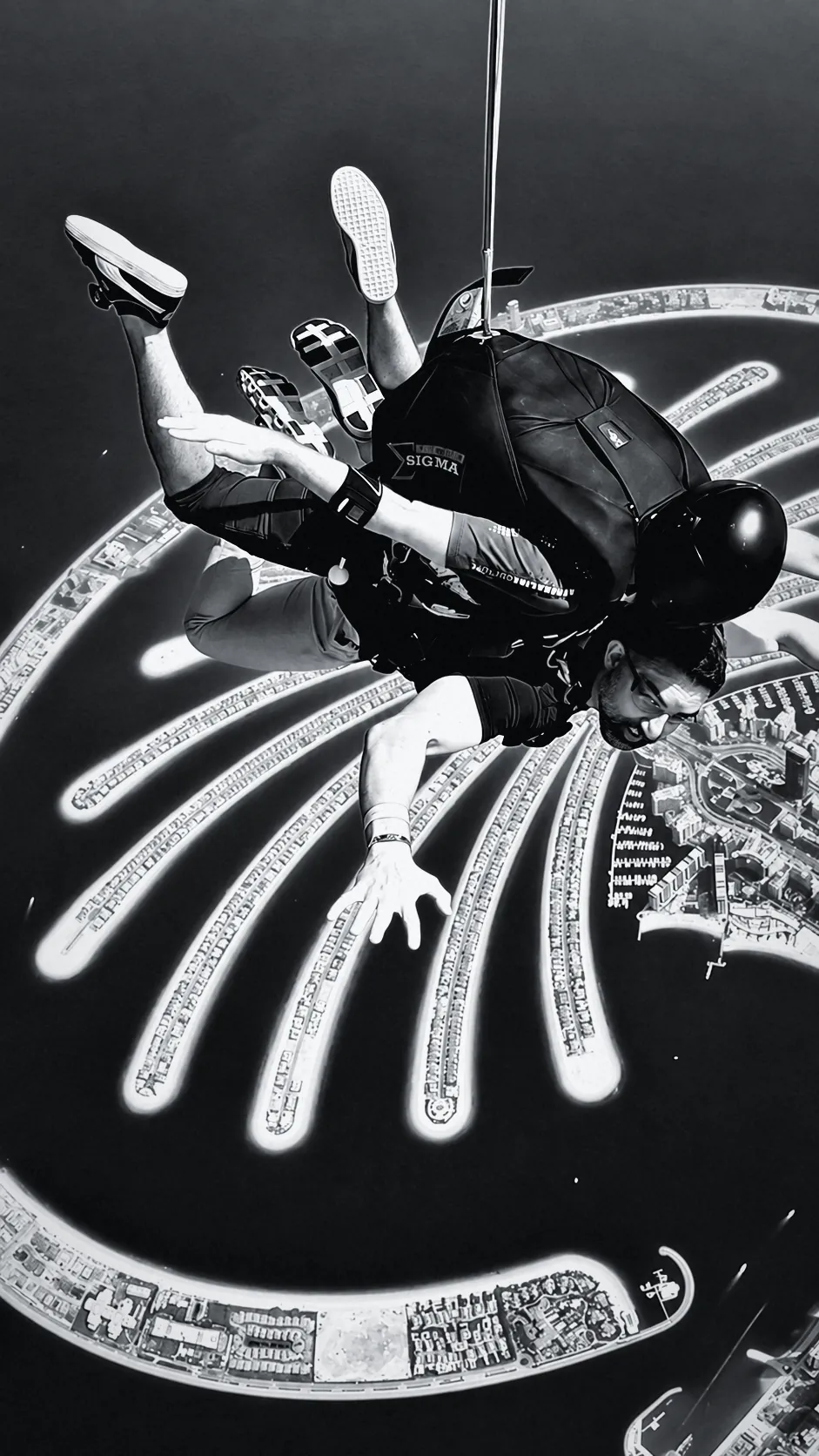 Houman Farzian in tandem freefall above the Palm Jumeirah, black and white